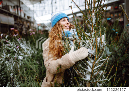 A young woman feels Christmas is approaching. Concept of holidays, traditions. 133226157