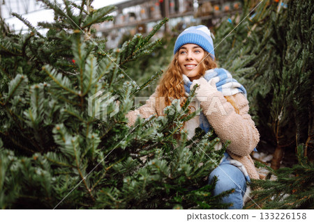 A young woman feels Christmas is approaching. Concept of holidays, traditions. 133226158