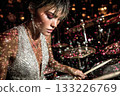 Female drummer performing on stage with sparkling lights and vibrant atmosphere 133226769