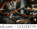 Female drummer performing passionately in stylish outfit with instruments 133226770