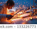 Drummer performing energetically with splashes of water and vibrant lights 133226773