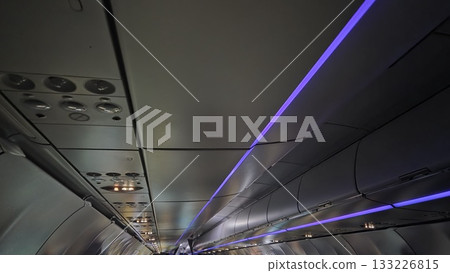 Modern airplane interior with ambient lighting and contemporary design Modern airplane interior with ambient lighting and contemporary design 133226815