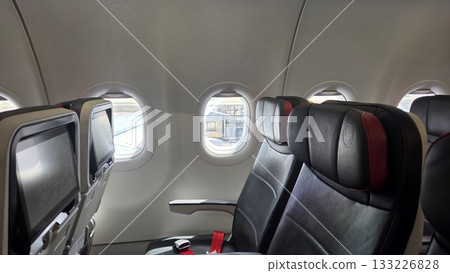Air travel experience with empty plane seats and window views for vacation and travel design 133226828
