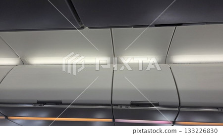 Interior of airplane cabin ceiling and overhead storage bins Interior of airplane cabin ceiling and overhead storage bins 133226830