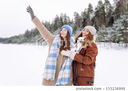 Happy friends having fun playing in winter park. Friends communicate and enjoying nature. 133226998
