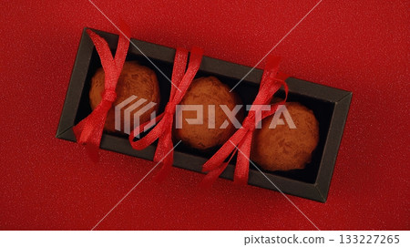 Chocolate Truffles in Elegant Box With Red Accents Create a Delightful Gift for Special Occasions Chocolate Truffles in Elegant Box With Red Accents Create a Delightful Gift for Special Occasions 133227265