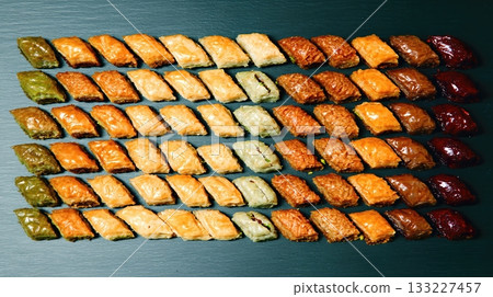 Assorted Maghrebi Sweets Featuring Baklava and Makrout Displayed in an Elegant Flat Lay 133227457