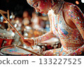 Colorful female drummer performing with vibrant glittery outfit on stage 133227525