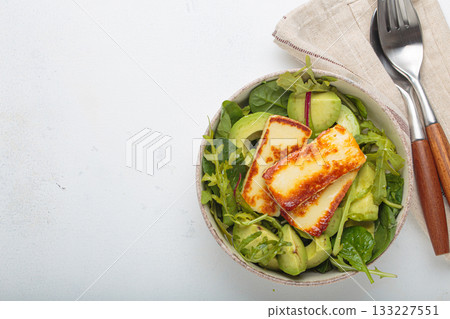 Halloumi avocado salad greens bowl healthy vegetarian diet nutrition top view copy space Halloumi avocado salad greens bowl healthy vegetarian diet nutrition top view copy space 133227551