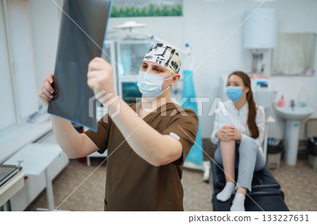 Doctor examines x-ray of patient leg. Foot and sprain concept. Sport exercise injuries. 133227631
