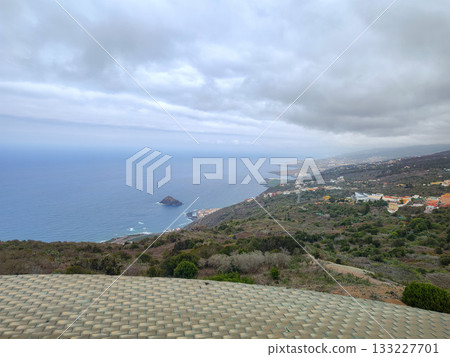 Experience the stunning coastal view overlooking the vast ocean and idyllic shoreline 133227701