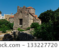 Ancient stone church with red 133227720