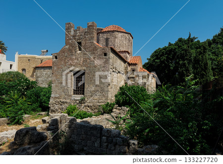 Ancient stone church with red 133227720