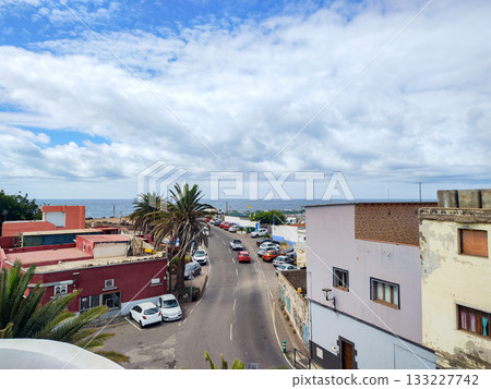 A scenic view of the tranquil coast with colorful buildings against a clear blue sky A scenic view of the tranquil coast with colorful buildings against a clear blue sky 133227742