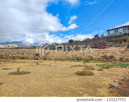 A breathtaking scenic landscape showcasing dry grass under a vibrant blue sky above 133227751