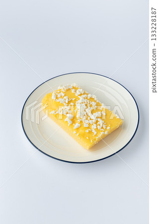 Traditional Ukrainian banosh with brynza cheese on plate, studio isolated 133228187