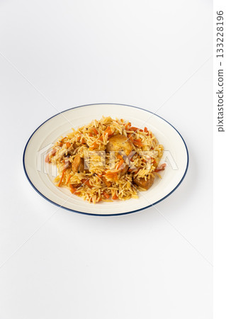 Chicken pilaf with basmati rice and carrots on plate, studio food photo on white 133228196