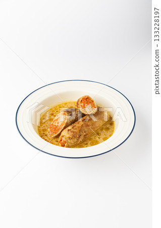 Stuffed meat rolls with carrot filling in savory gravy on a white background 133228197