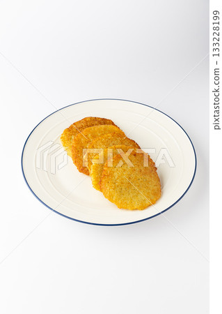 Ukrainian deruny , crispy potato pancakes stacked on a plate, isolated on white 133228199