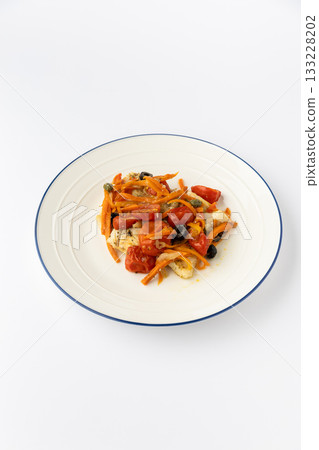 Mediterranean baked fish with tomatoes, olives, capers and carrots on white plate Mediterranean baked fish with tomatoes, olives, capers and carrots on white plate 133228202