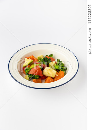 Colorful mixed vegetables in bowl, broccoli, zucchini, peppers, carrots. Healthy studio food shot Colorful mixed vegetables in bowl, broccoli, zucchini, peppers, carrots. Healthy studio food shot 133228205