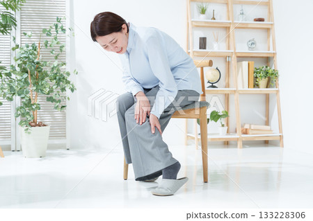Woman with leg cramps Woman with leg cramps 133228306