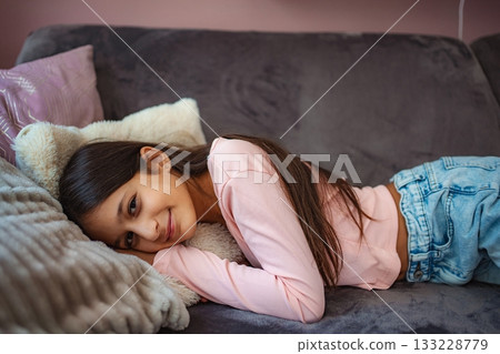 Young girl relaxing at home smiling happily Young girl relaxing at home smiling happily 133228779