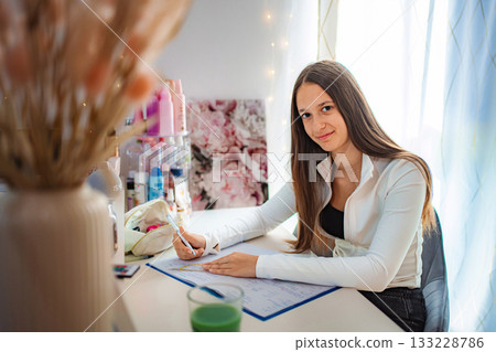 Teenager girl writing on desk at home 133228786