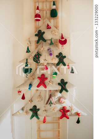 A handmade textile Christmas tree with felt gingerbread cookies A handmade textile Christmas tree with felt gingerbread cookies 133229000