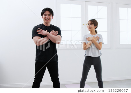 Young woman receiving training from a personal trainer Young woman receiving training from a personal trainer 133229057
