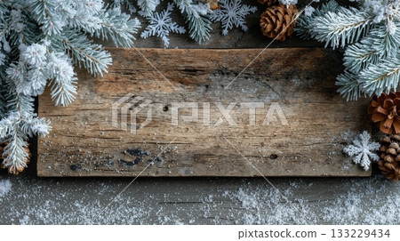 Abstract wooden background with snow-covered pine branches and pinecones for winter and holiday themes Abstract wooden background with snow-covered pine branches and pinecones for winter and holiday themes 133229434