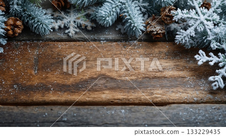 Textured wooden background with snowy fir branches and pine cones creating a winter holiday atmosphere 133229435