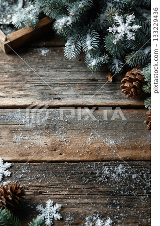 Rustic vertical background with snowflakes, pine cones, and evergreen branches on old wood planks, perfect for winter and holiday themes Rustic vertical background with snowflakes, pine cones, and evergreen branches on old wood planks, perfect for winter and holiday themes 133229436