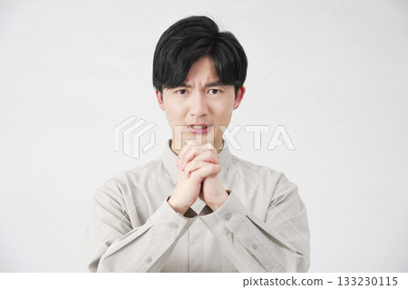 Man pleading, 20s, white background, looking at camera 133230115