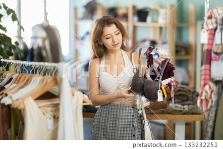 Young woman chooses underwear in clothing store 133232251