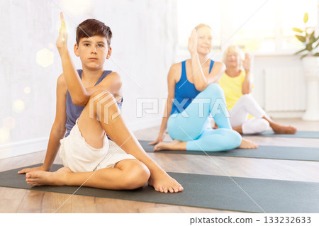 Group of people generation on mats doing yoga exercise lord of fishes pose. Group of people generation on mats doing yoga exercise lord of fishes pose. 133232633