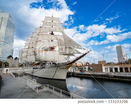 The Nippon Maru with its sails set and the view of Minato Mirai 133233206