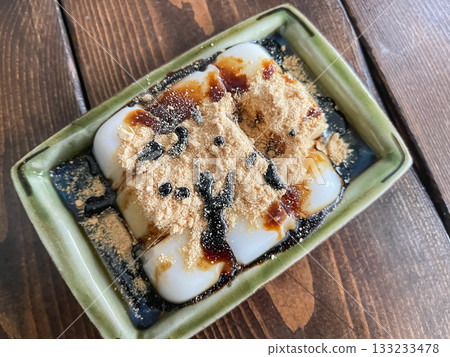 Sweet milk mochi made from konjac flour, topped with brown sugar syrup and kinako. Sweet milk mochi made from konjac flour, topped with brown sugar syrup and kinako. 133233478