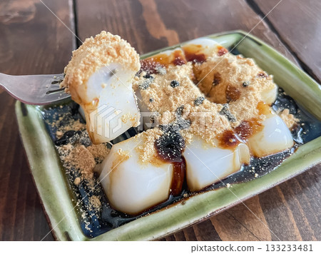 Sweet milk mochi made from konjac flour, topped with brown sugar syrup and kinako. 133233481
