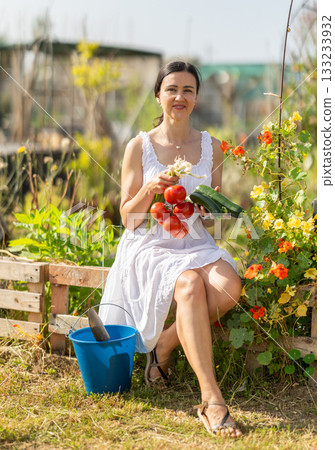Adult woman with vegetable harvest in cottage garden Adult woman with vegetable harvest in cottage garden 133233932