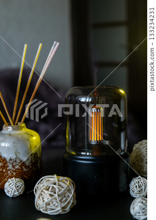 Home fragrance aromatic diffuser with essential oil. Modern air humidifier at home. Improving the comfort of wellbeing living in house. Ultrasonic aroma perfume steam 133234231