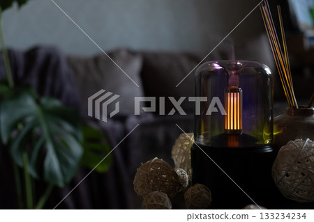 Home fragrance aromatic diffuser with essential oil. Modern air humidifier at home. Improving the comfort of wellbeing living in house. Ultrasonic aroma perfume steam 133234234