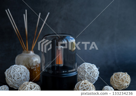 Home fragrance aromatic diffuser with essential oil. Modern air humidifier at home. Improving the comfort of wellbeing living in house. Ultrasonic aroma perfume steam 133234236