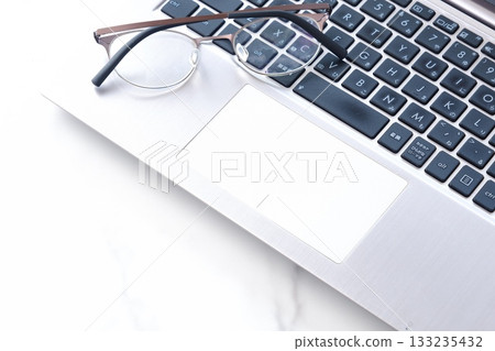 Image of a business scene, doing desk work on a laptop 133235432