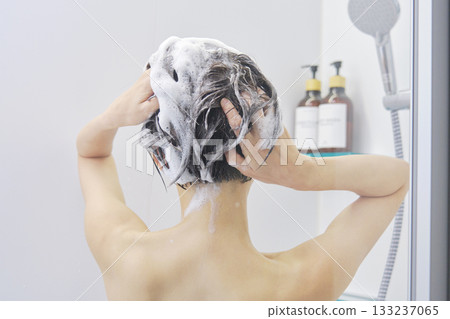 Woman washing her hair in the bathroom, back view Woman washing her hair in the bathroom, back view 133237065