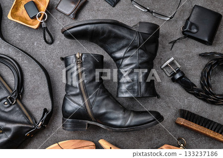 Side-zip boots and accessories on concrete 133237186
