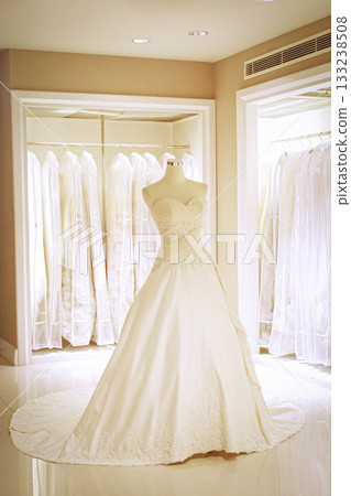 Elegant Bridal Gown on Display in Luxury Boutique Showroom with Long Train, Lace and Ivory White 133238508