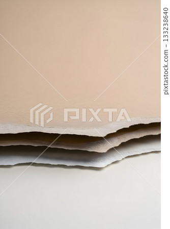Stack of Beige Deckle-Edge Handmade Paper Close-Up 133238640