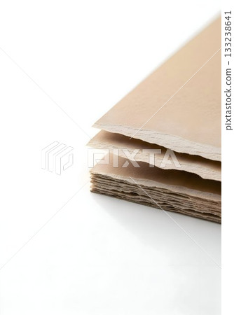 Stack of Beige Deckle-Edge Handmade Paper Close-Up 133238641