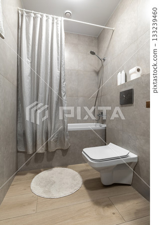 Minimalist Bathroom with Shower Curtain and Wall Hung Toilet Minimalist Bathroom with Shower Curtain and Wall Hung Toilet 133239460